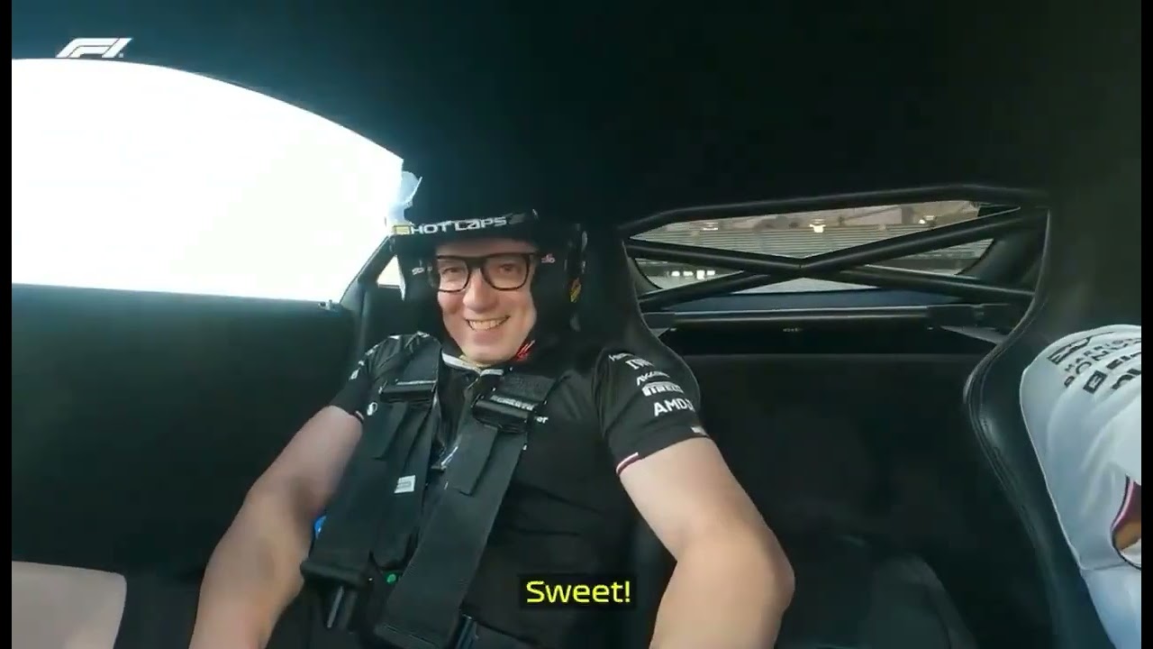 Peter Bonnington in a Formula 1 car with a black Mercedes shirt and black helmet
